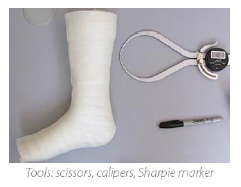 Image showing a fiberglass cast, a digital caliper, and a Sharpie marker.